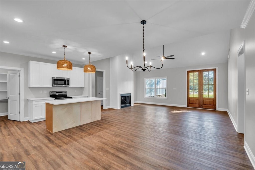 2767 Claxton Dairy Road Dublin, GA 31021 - Photo 8 of 51 a view of a kitchen with a sink wooden floor and windows