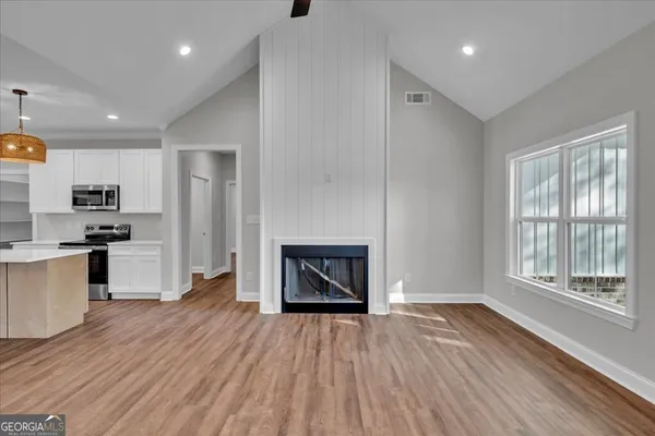 a kitchen with stainless steel appliances a stove microwave and a sink