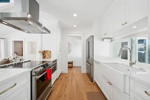 a kitchen with stainless steel appliances a sink stove and refrigerator
