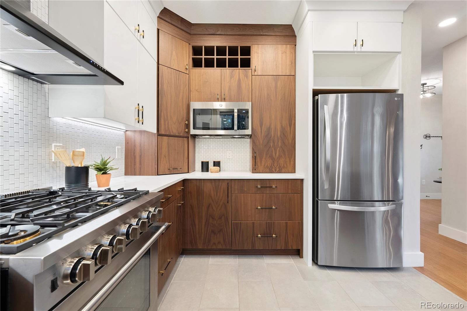 4742 16th Street Boulder, CO 80304 - Photo 13 of 48 a kitchen with stainless steel appliances granite countertop a stove and a refrigerator