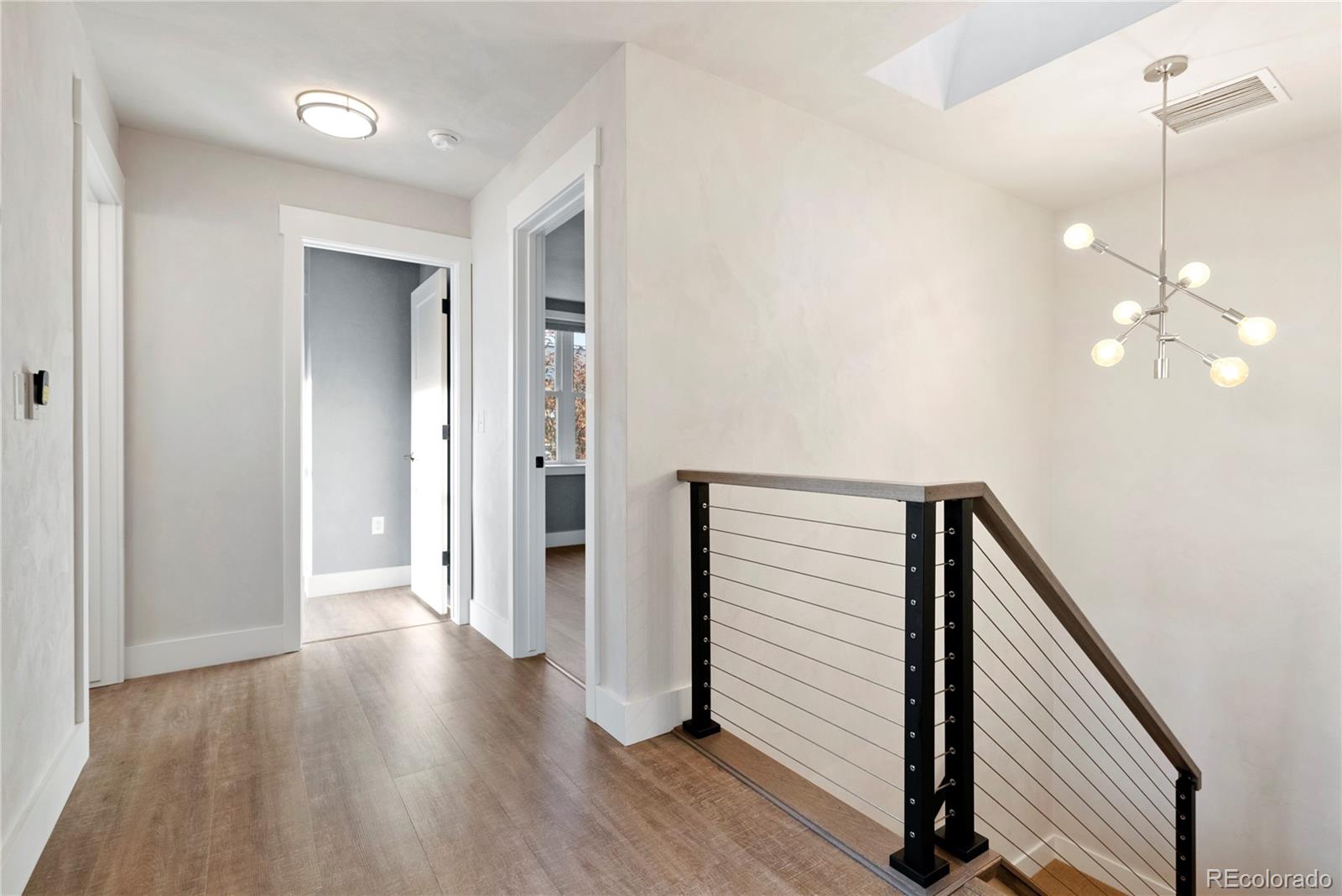 4742 16th Street Boulder, CO 80304 - Photo 17 of 48 a view of a hallway with wooden floor and stairs