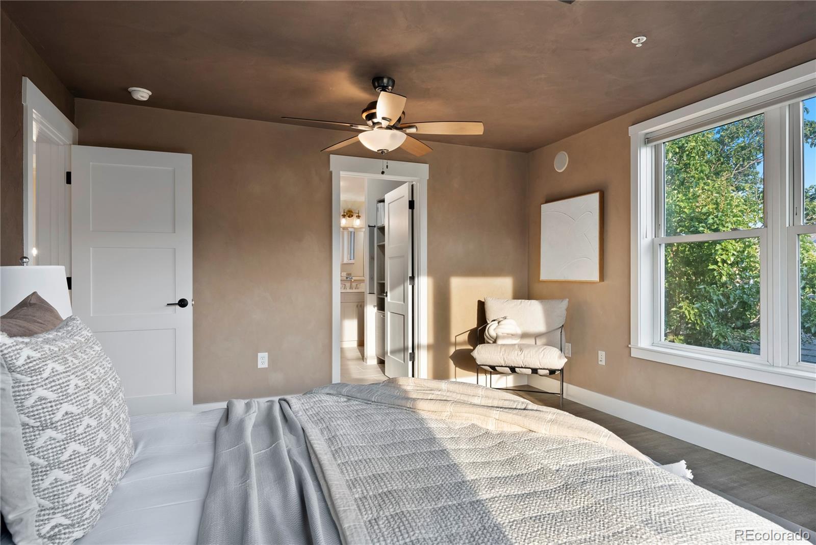 4742 16th Street Boulder, CO 80304 - Photo 20 of 48 a bedroom with a large bed and a chandelier