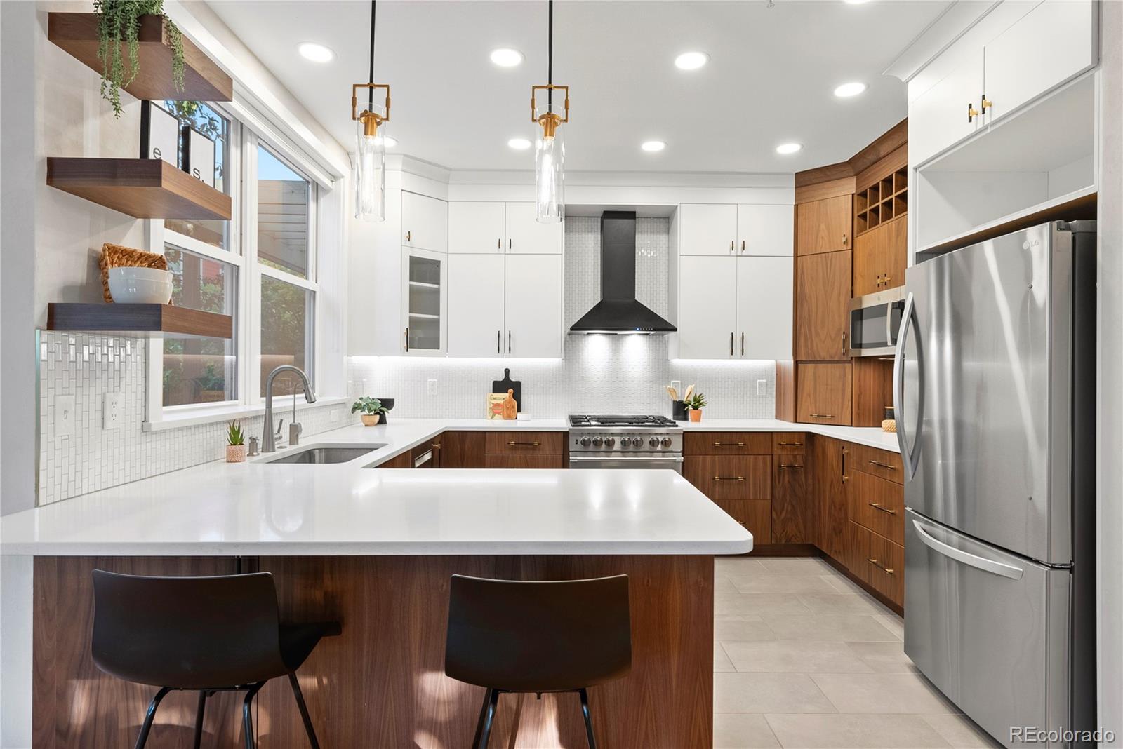 4742 16th Street Boulder, CO 80304 - Photo 9 of 48 a kitchen with stainless steel appliances a dining table chairs stove and refrigerator
