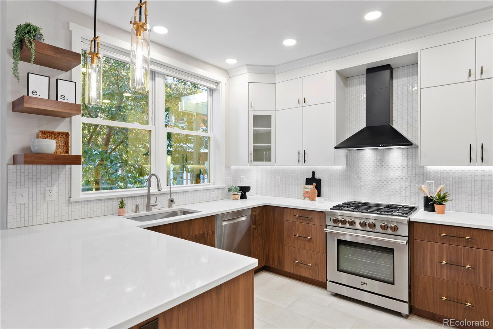 4742 16th Street Boulder, CO 80304 - Photo 10 of 48 a kitchen with a stove a sink a window and cabinets
