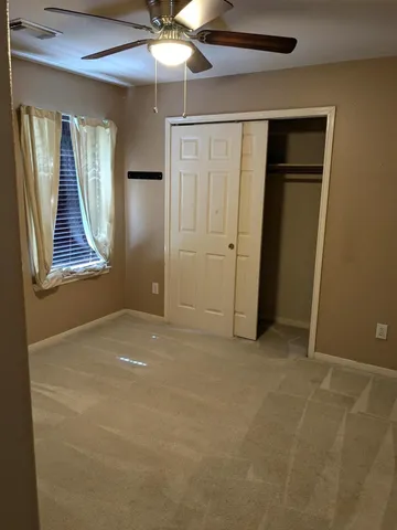 an empty room with windows and closet