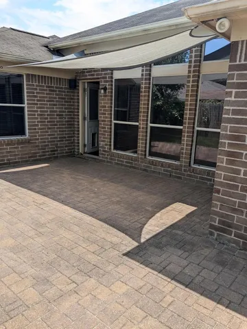 a view of a brick house with a large window