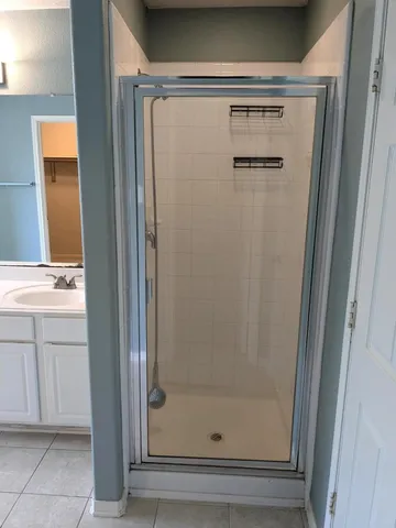 a bathroom with a shower and vanity