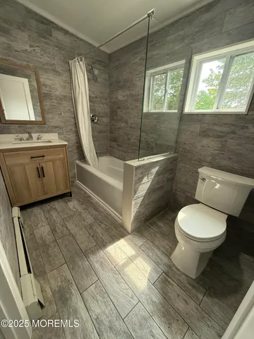 a bathroom with a toilet a sink and bathtub