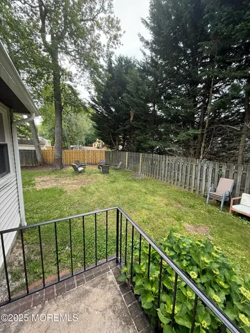 a view of a garden with wooden fence
