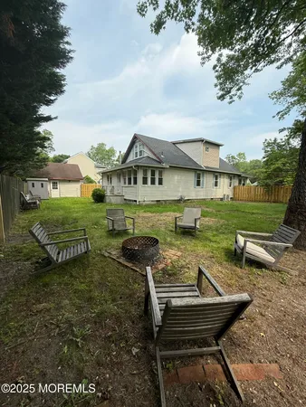 a view of a house with garden and sitting area