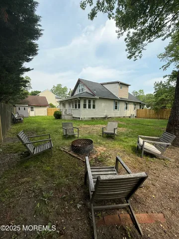 a view of a house with garden and sitting area
