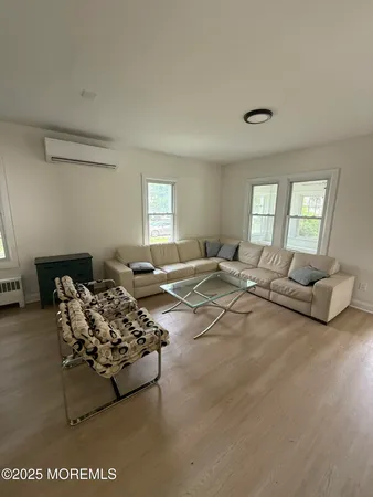 a living room with furniture window and a table