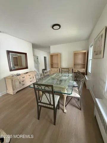 a view of a dining room with furniture and a flat screen tv