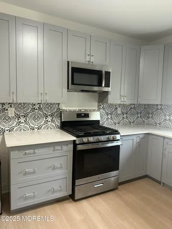 a kitchen with granite countertop a stove and a sink