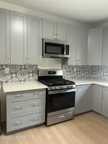 a kitchen with granite countertop a stove and a sink