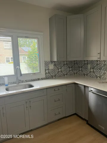 a kitchen with a sink and cabinets