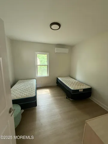 a view of room with window and hardwood floor