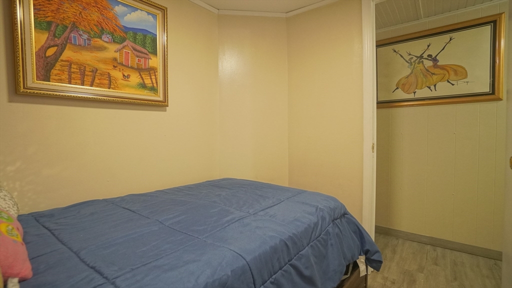93 Grochmal Avenue, Unit 126 Springfield, MA 01151 - Photo 28 of 35 a bedroom with a bed and wall painting