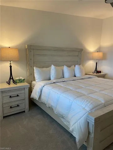 a bedroom with a bed and a lamp