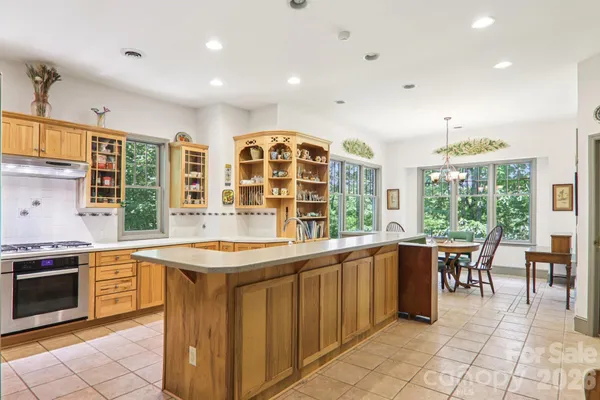 a kitchen with stainless steel appliances granite countertop a stove and a sink