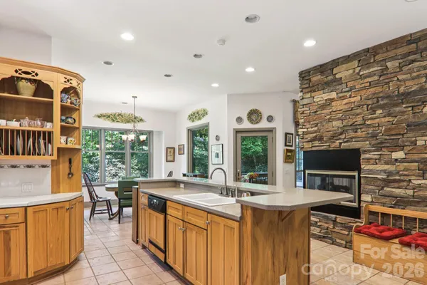 a kitchen with stainless steel appliances granite countertop a sink and a stove