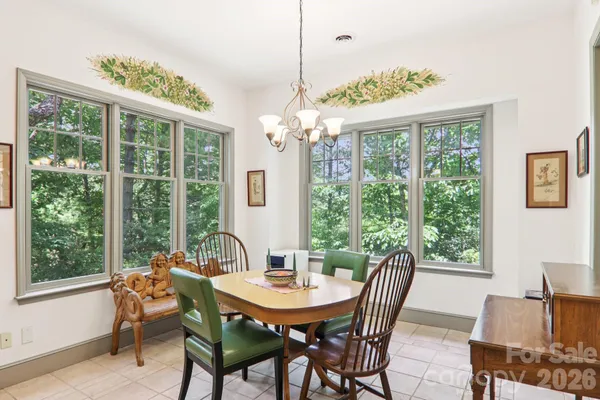a dining room with furniture a chandelier and a rug