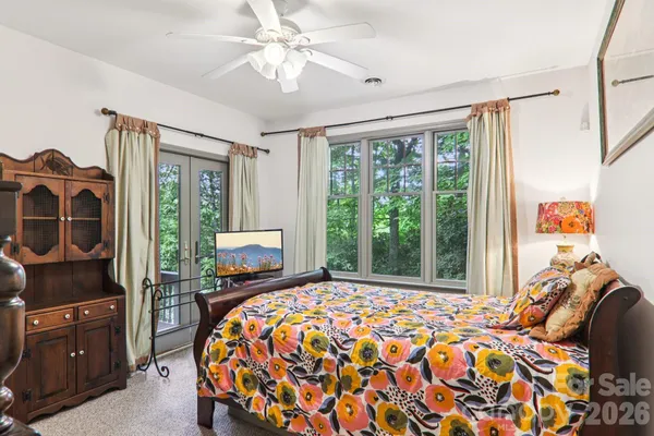 a bedroom with a bed and a chandelier