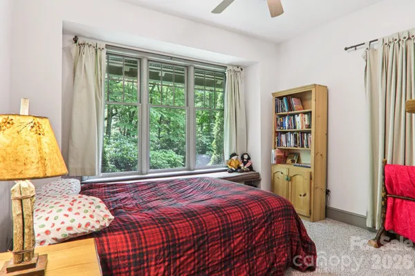 a bed sitting in a bedroom next to a window