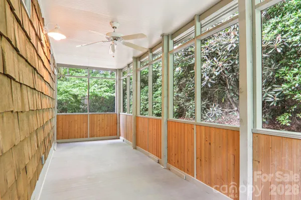a view of a porch with a floor to ceiling window and a ceiling fan