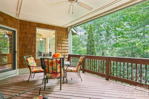 a view of a chairs and table in the balcony