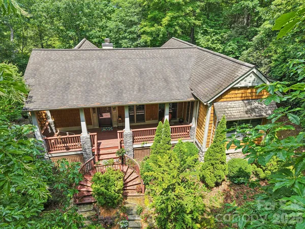 an aerial view of a house with a yard table and chairs