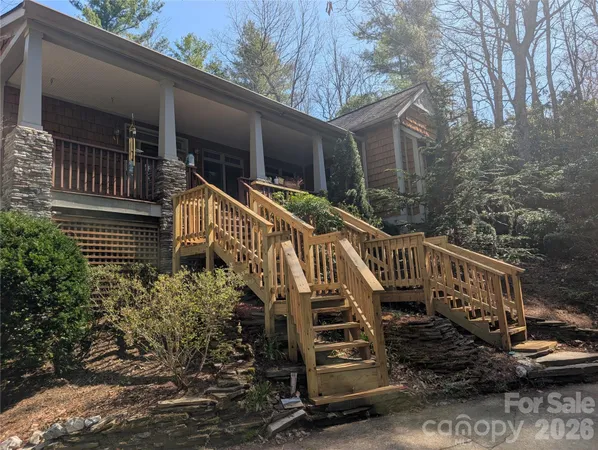 a view of a house with wooden fence