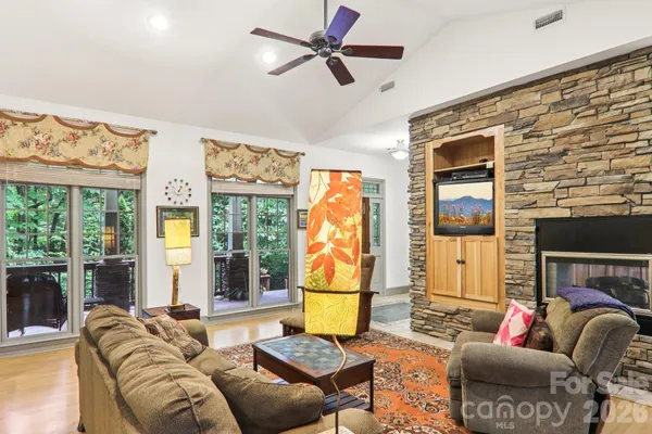 a living room with furniture and a floor to ceiling window