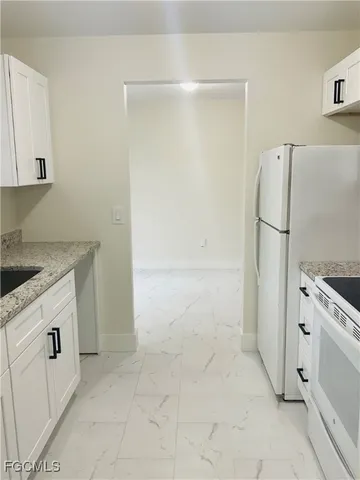 a utility room with cabinets washer and dryer