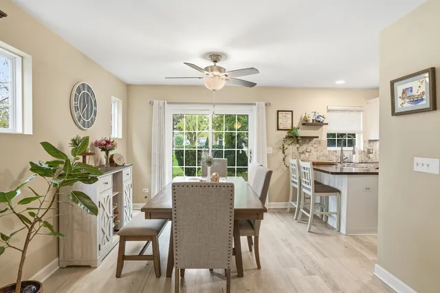a dining room with furniture a window and a chandelier