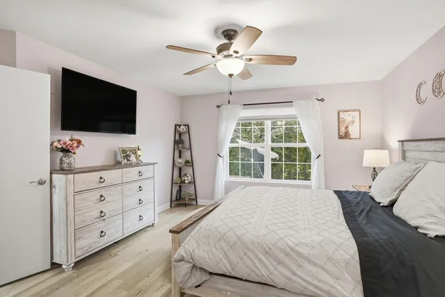 a bedroom with a bed and a flat screen tv