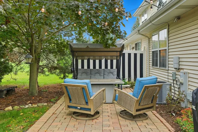 a view of a patio with table and chairs with wooden floor and fence