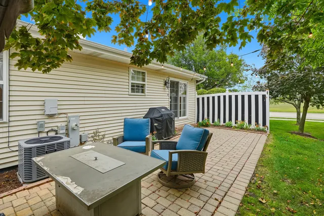 a view of a patio with a table and chairs