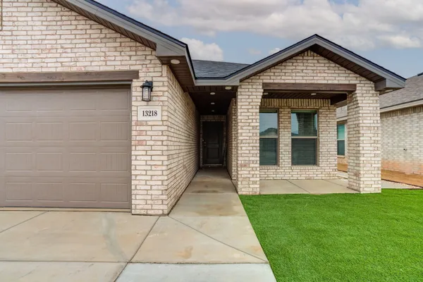 a view of a house with a small yard and a large window