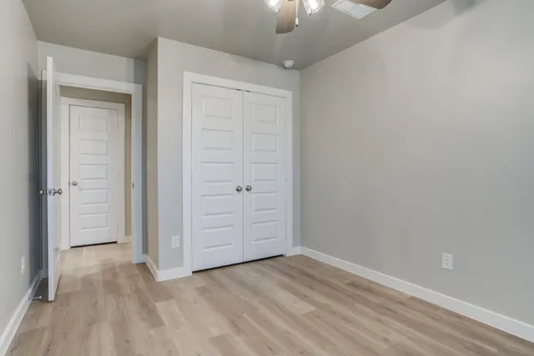 an empty room with closet area