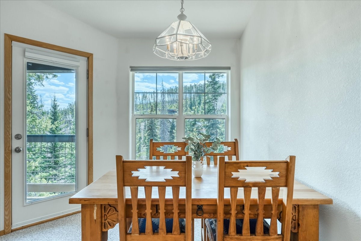 91399 Ryan Gulch Road, Unit B6 Silverthorne, CO 80498 - Photo 7 of 36 a view of a dining room with furniture window and wooden floor