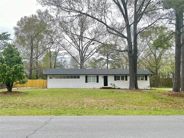 a front view of house with yard and trees