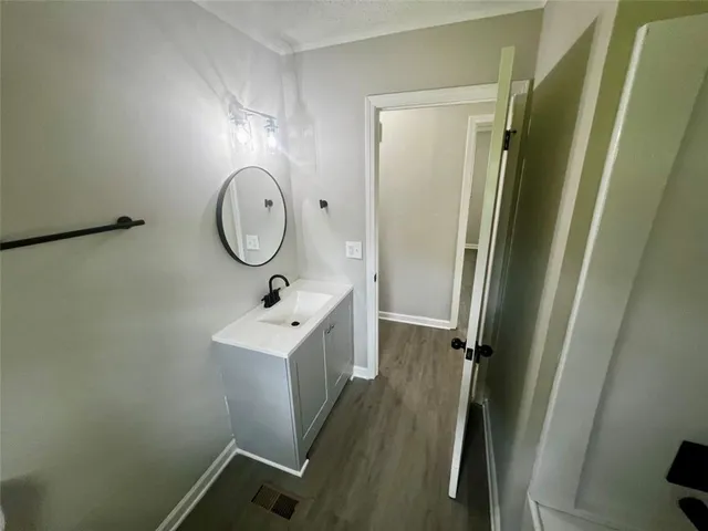 a bathroom with a sink a mirror a vanity and a shower
