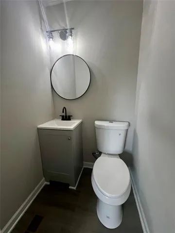 a bathroom with a toilet sink and a mirror