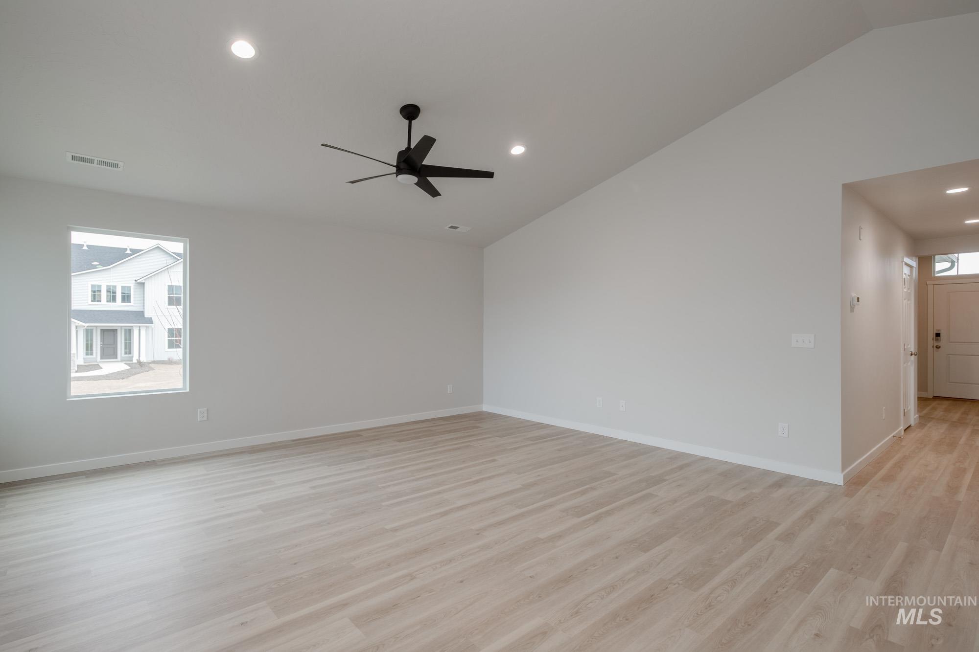 3090 South Maple Rnch Way Nampa, ID 83686 - Photo 11 of 22 Empty room with lofted ceiling, light wood-type flooring, recessed lighting, and ceiling fan