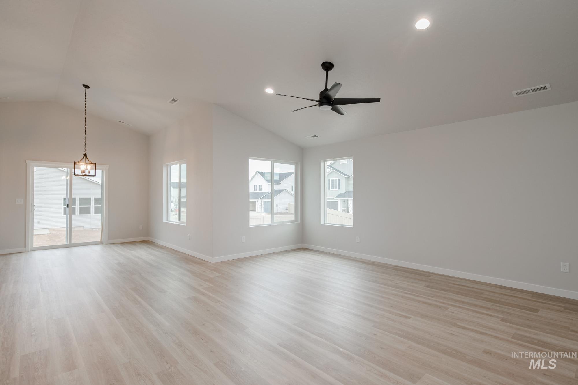 3090 South Maple Rnch Way Nampa, ID 83686 - Photo 12 of 22 Empty room featuring vaulted ceiling, light wood-style flooring, ceiling fan, and recessed lighting