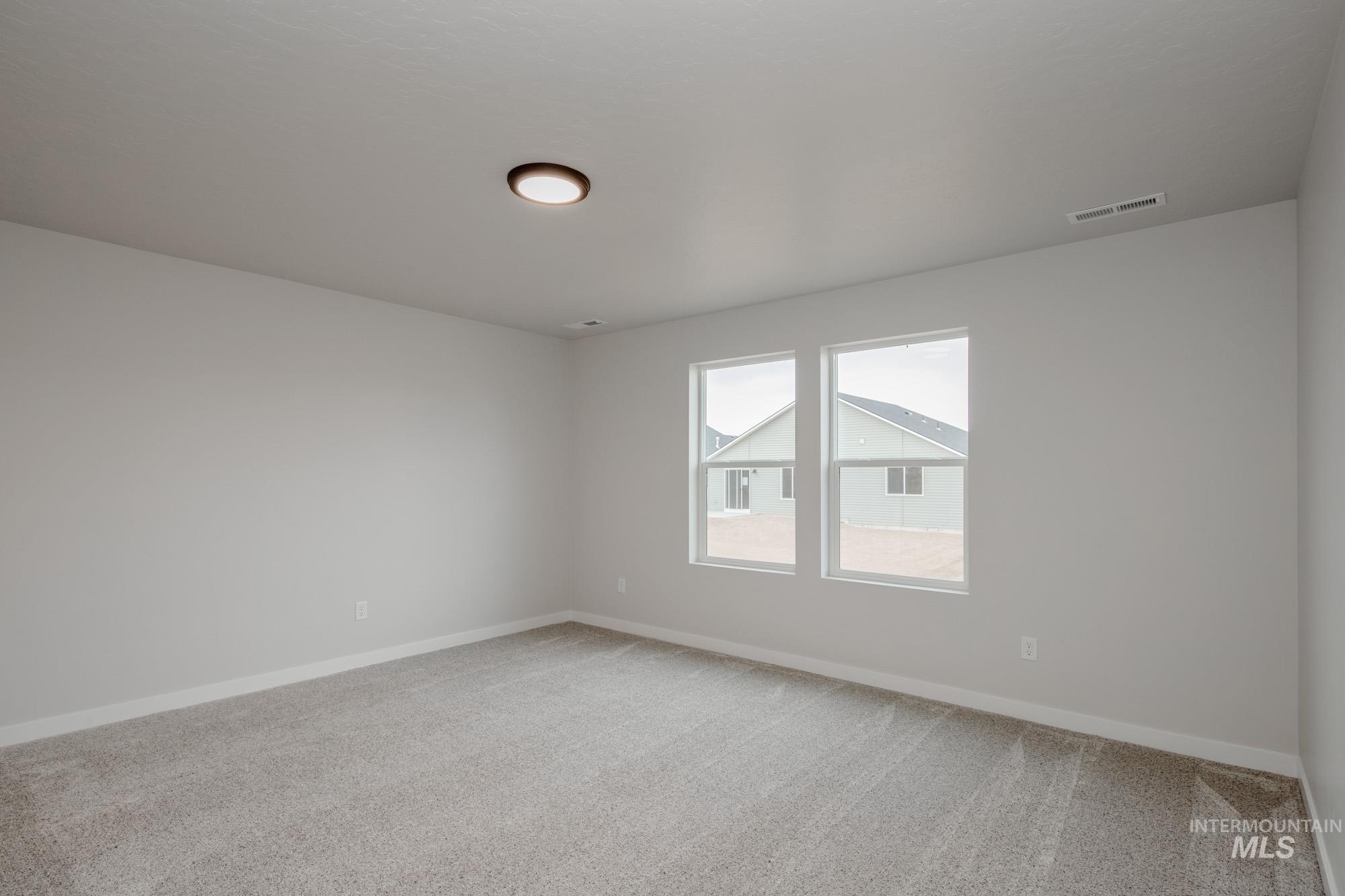 3090 South Maple Rnch Way Nampa, ID 83686 - Photo 19 of 22 Empty room featuring light carpet and baseboards