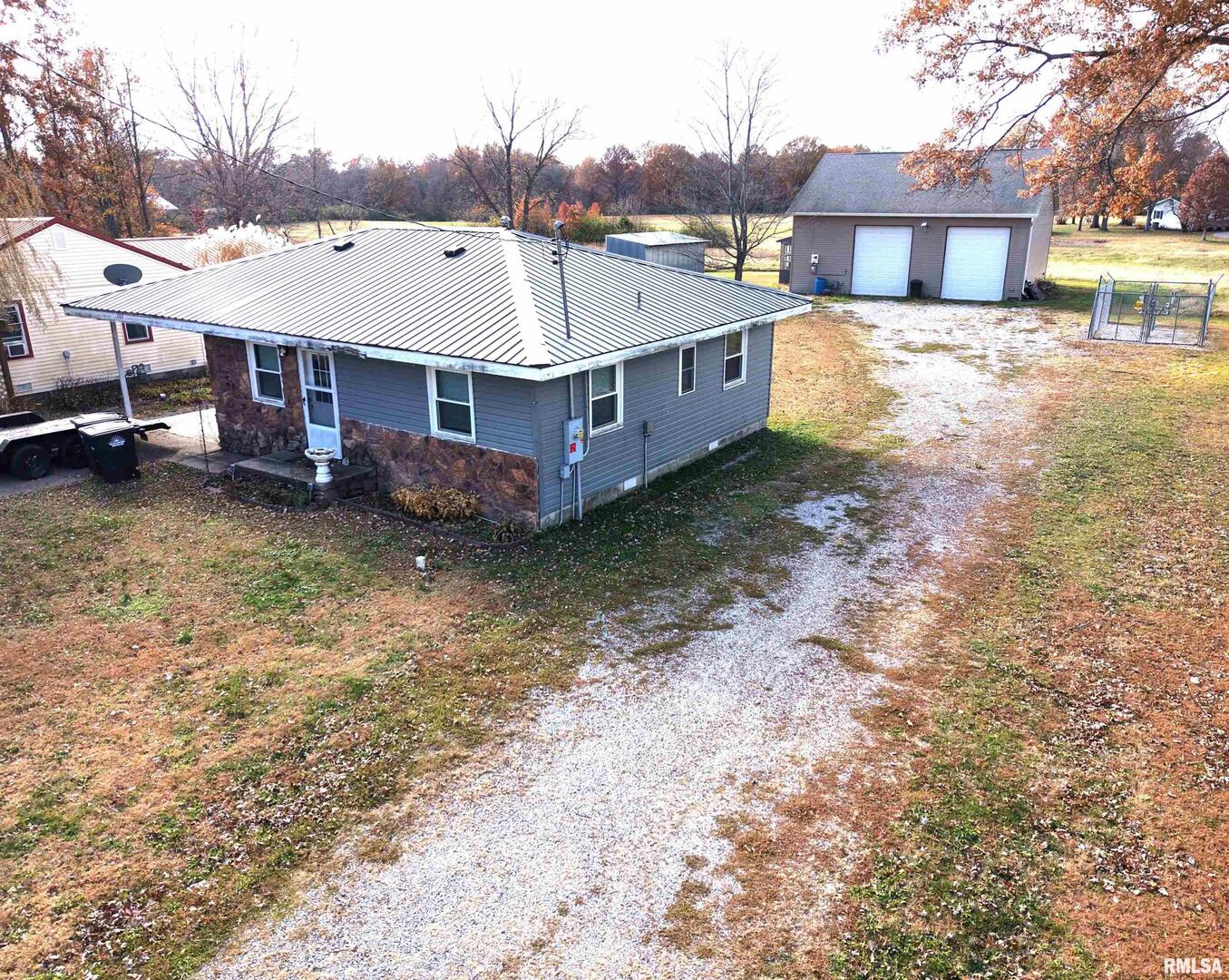 a view of a house with a yard and sitting area