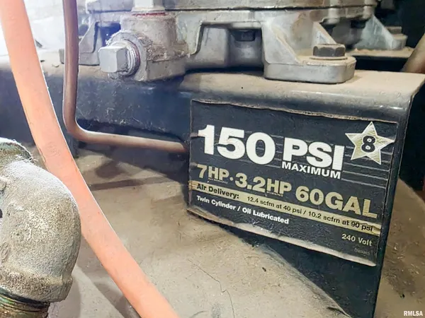 a view of livingroom with furniture and a refrigerator
