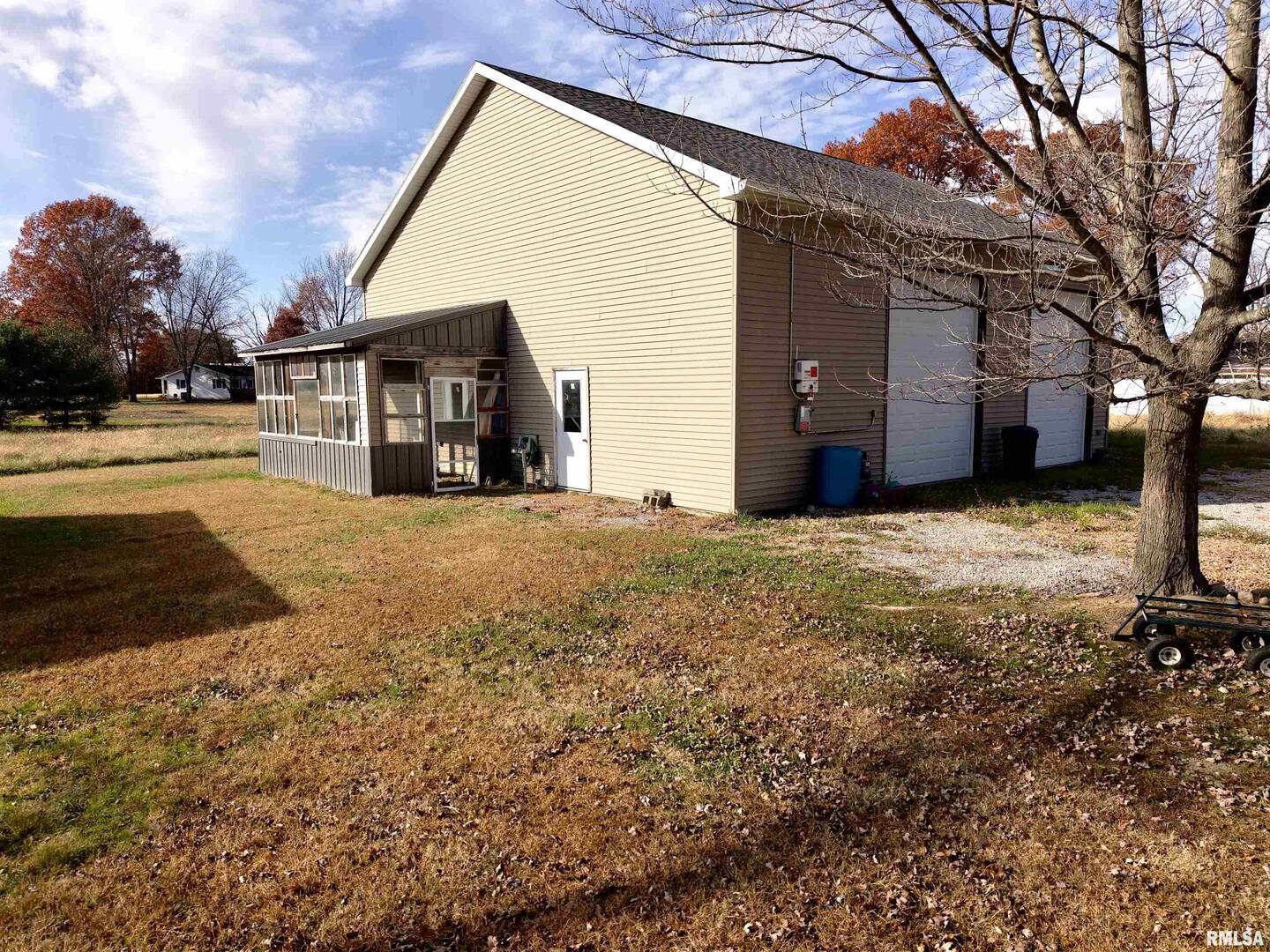 103 Watkins Street Cisne, IL 62823 - Photo 3 of 85 a view of a house with a yard and large tree